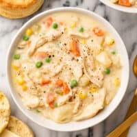 Chicken pot pie soup in a white bowl.