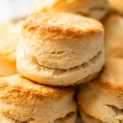 Cream biscuits stacked on a plate.