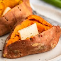 Microwave sweet potato cut open with butter and salt and pepper.