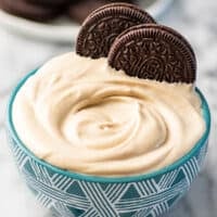 Peanut butter whipped cream in a blue bowl with Oreos.