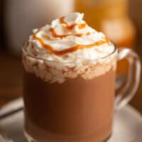 Salted caramel mocha in a glass mug with whipped cream.