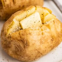 Microwave baked potato with butter.
