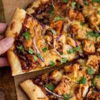 BBQ Chicken Pizza slice being picked up.