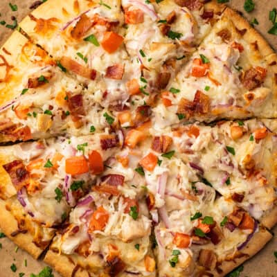 Overhead photo of chicken bacon ranch pizza on parchment paper.