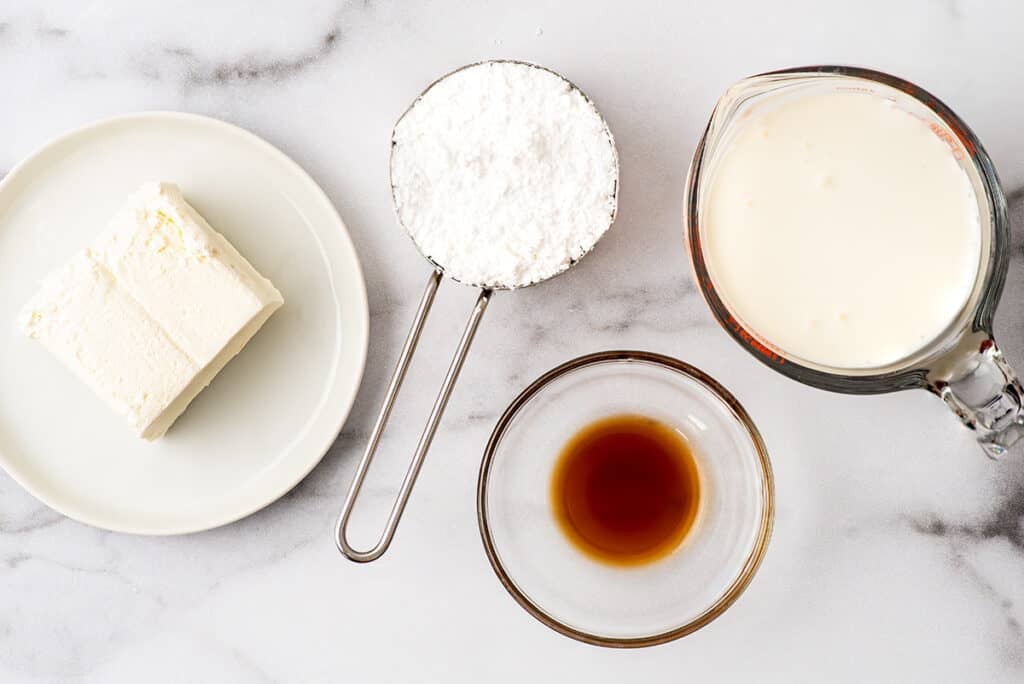 Cream cheese whipped cream ingredients on a counter.