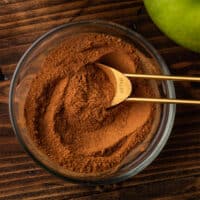 Apple pie spice in a bowl with a measuring spoon.