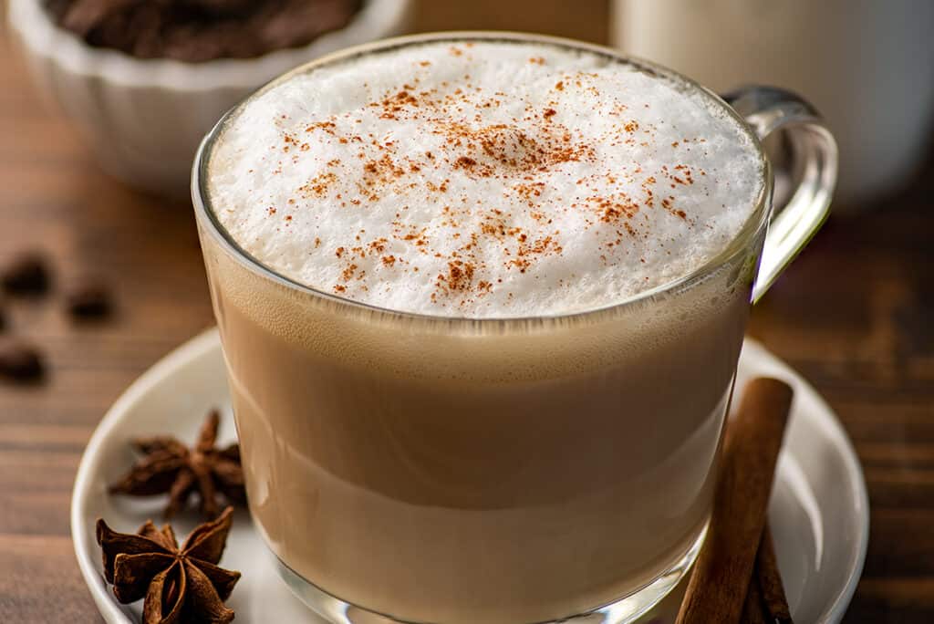 Close up photo of chai tea latte with cinnamon sprinkled on top.