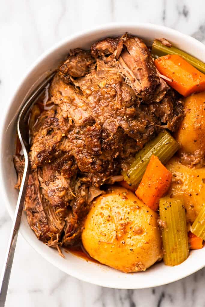 Close up photo of pot roast in a bowl.
