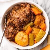 Red wine pot roast with vegetables in a serving bowl.