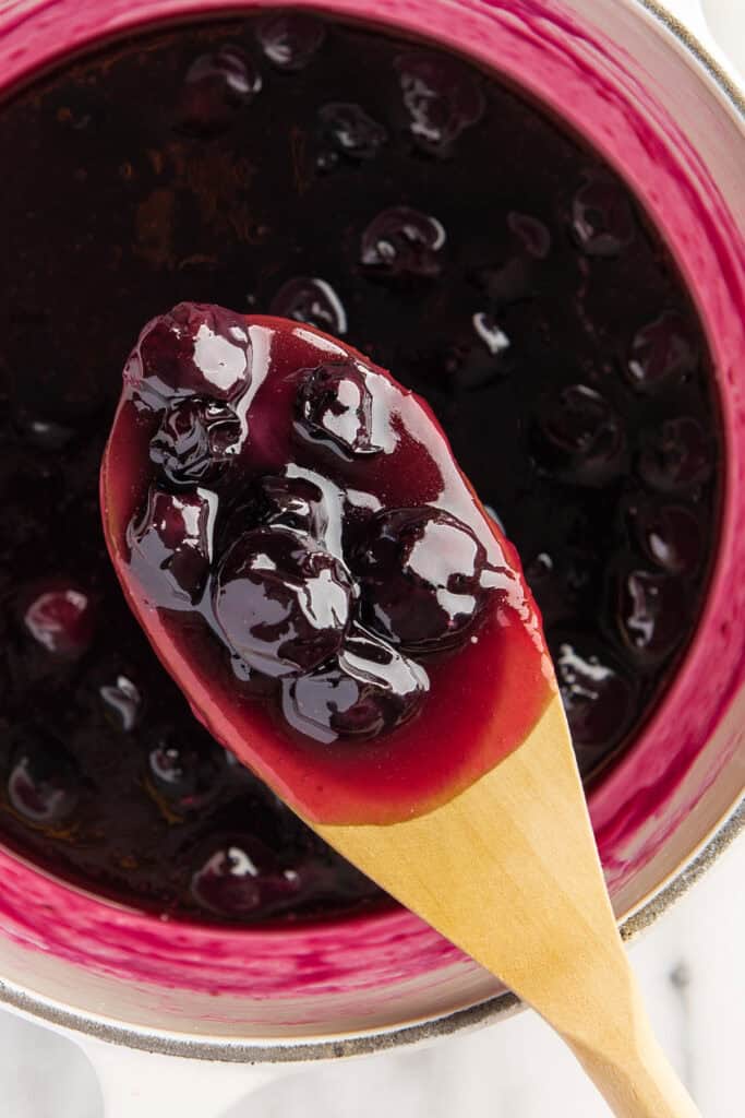 Close up photo of blueberries in homemade blueberry syrup.