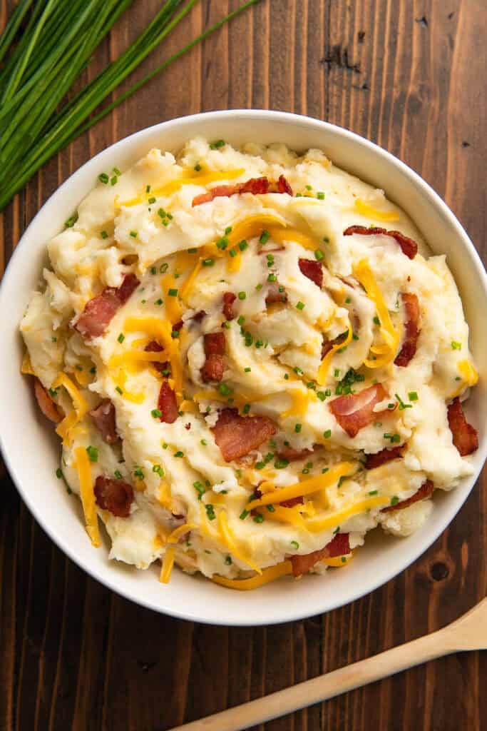 Loaded mashed potatoes in a white bowl