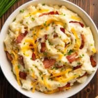 Loaded mashed potatoes in a white bowl