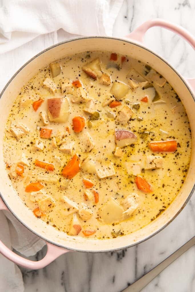Creamy chicken and potato soup in a pot.
