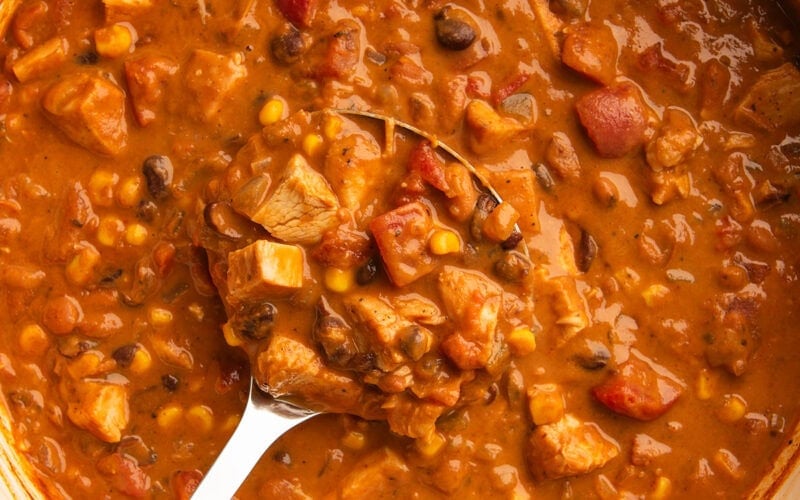 Chicken taco soup being ladled out of a pot