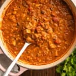 Chicken taco soup being ladled out of a pot