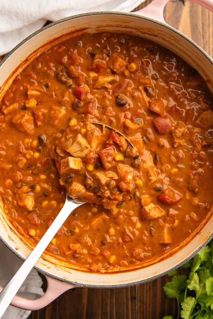 Chicken taco soup being ladled out of a pot